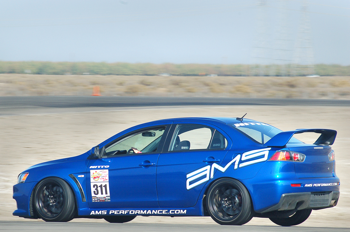 an image of a small car driving around the track