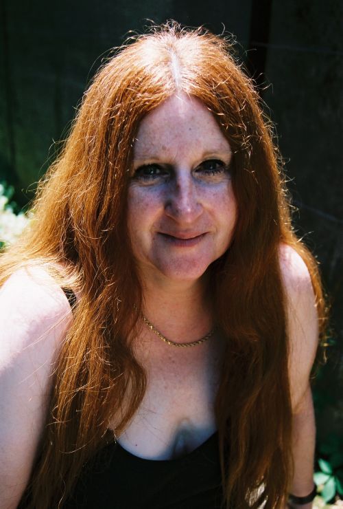 a woman with freckled hair and no  smiling