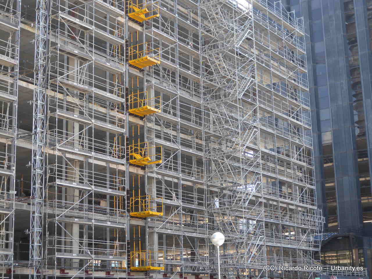 construction worker looking at scaffolding on city building