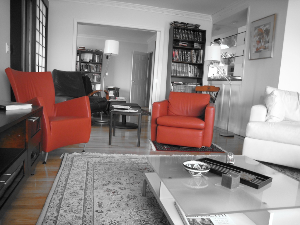 red leather chairs sit in front of a television