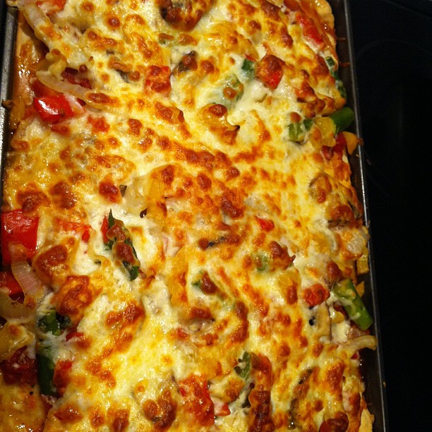 pizza with cheese and peppers in a pan