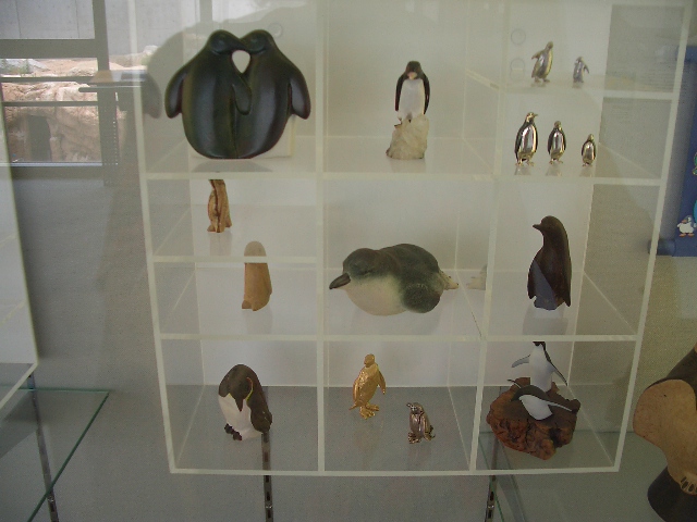 a display case containing an animal figure, bird and other items