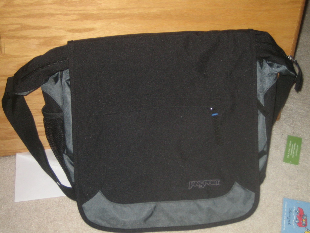 the side of a black messenger bag, with a grey strap
