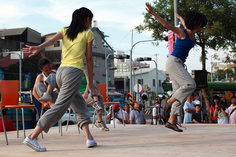 two young people are jumping in the air