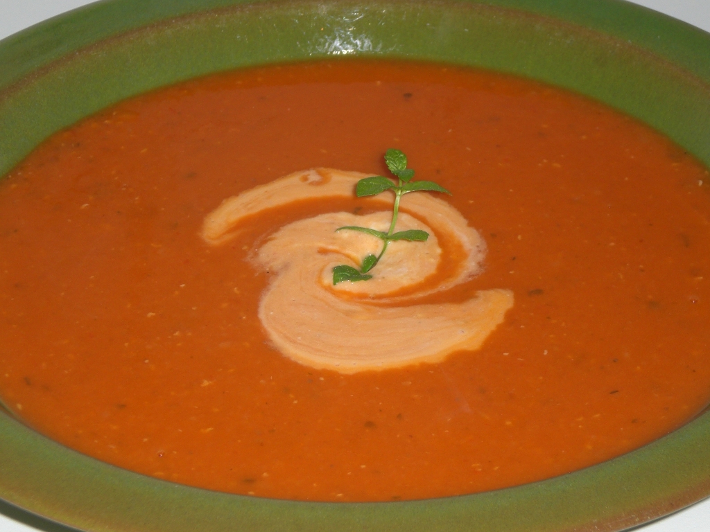 a bowl of red soup on a stove