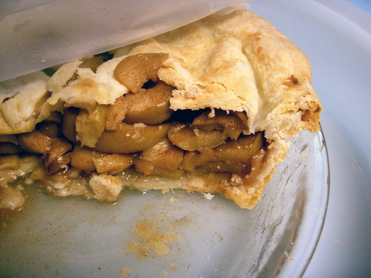 a partially eaten apple pie sitting on a plate