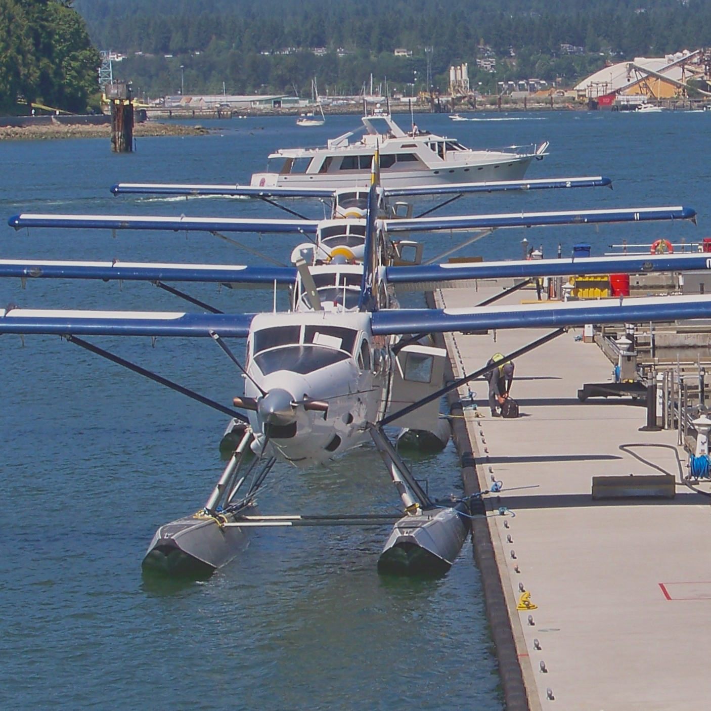 a row of air plane parked on the edge of a pier