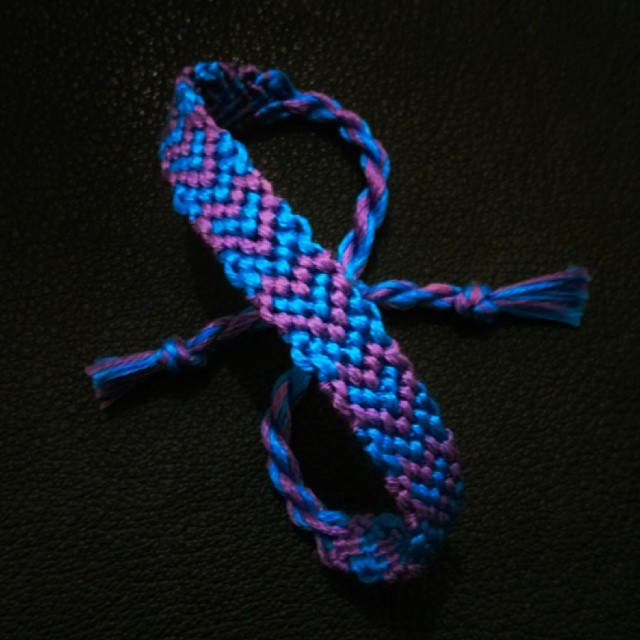 a purple and blue ided rope on a black surface