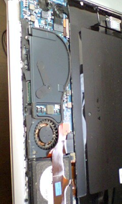 this is an open laptop computer with a large broken piece in it
