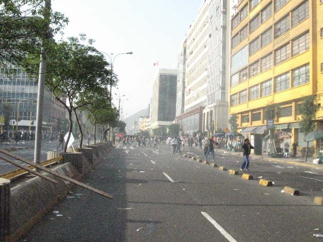 people walking down the street by the building in the city