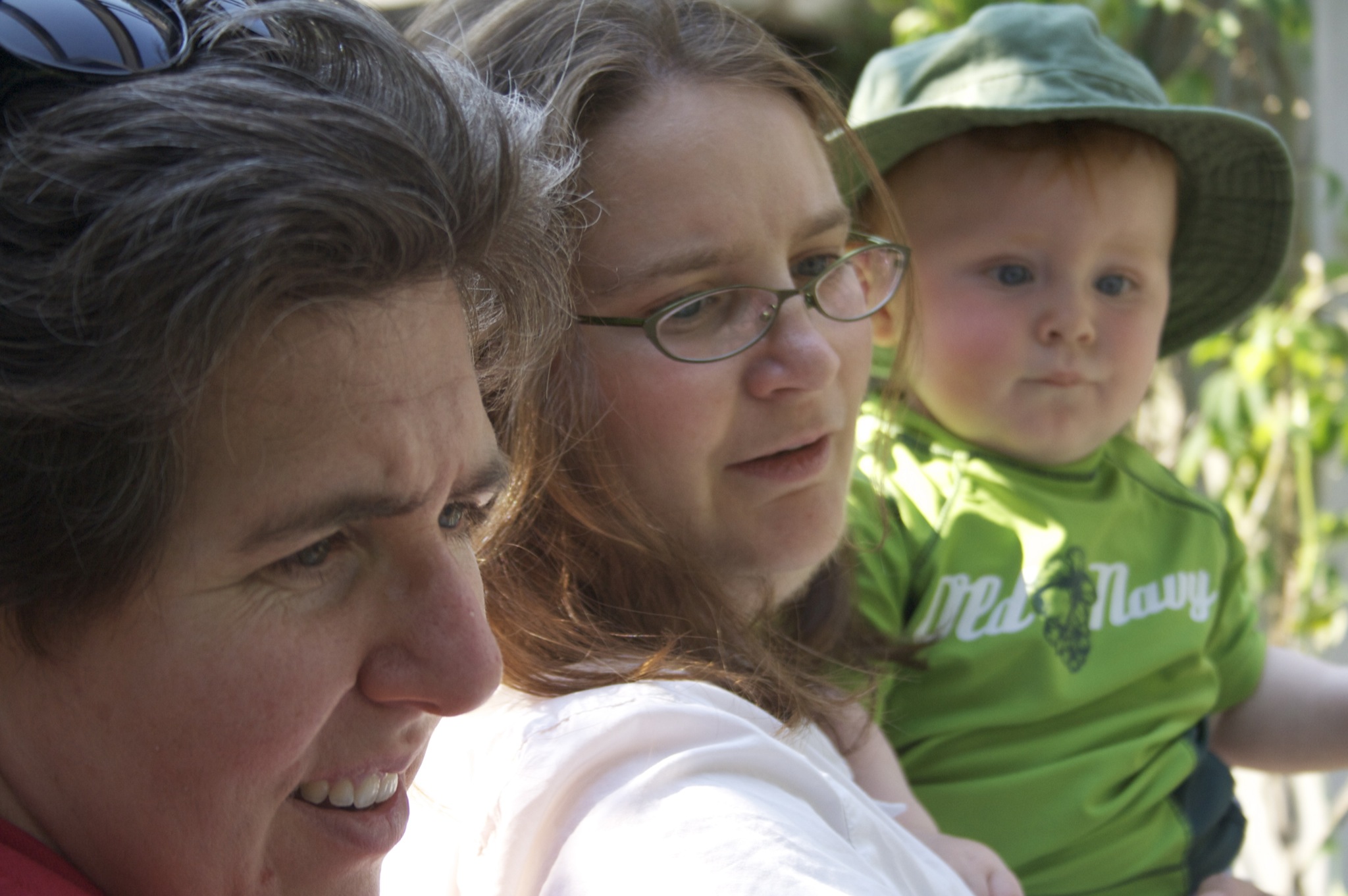 three adults and one child wearing green shirts