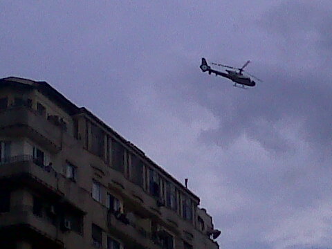 there is a helicopter flying over a city