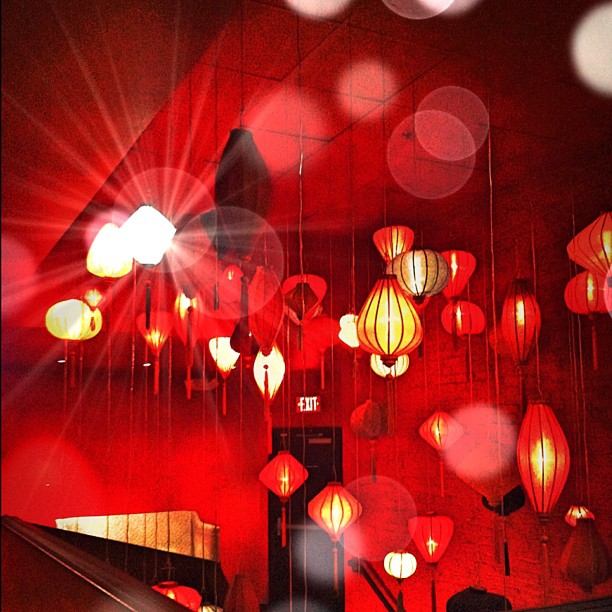 many red lanterns hanging in a room