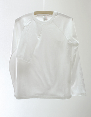 a long sleeved white shirt hanging up on a wooden hanger