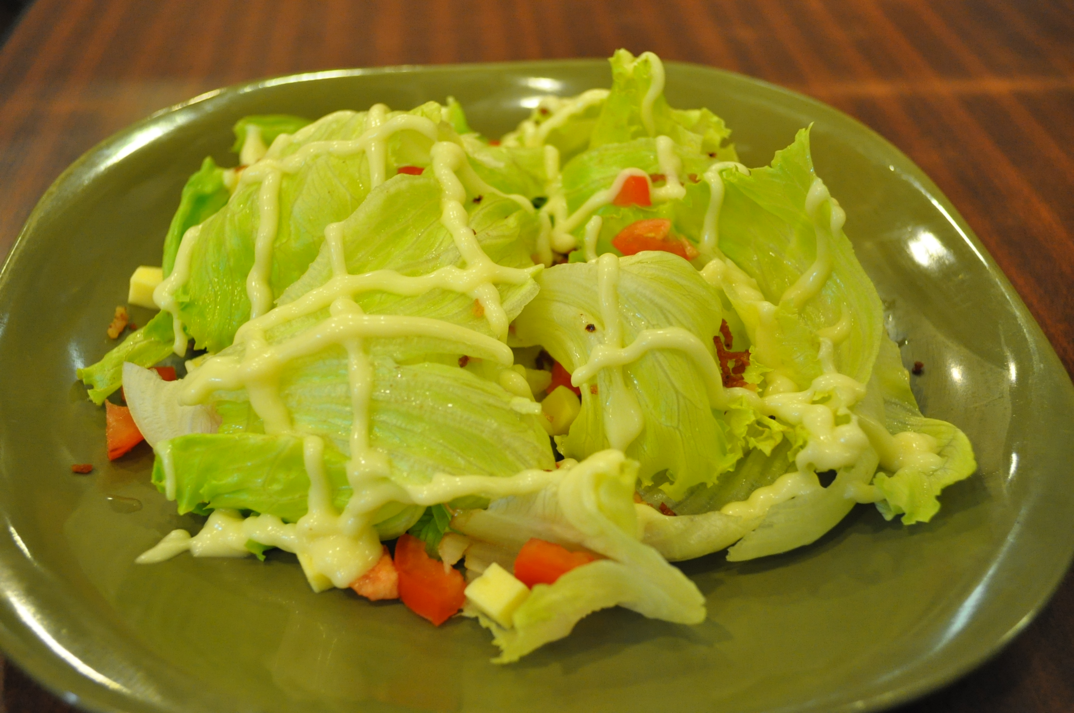 some lettuce on a green plate with vegetables