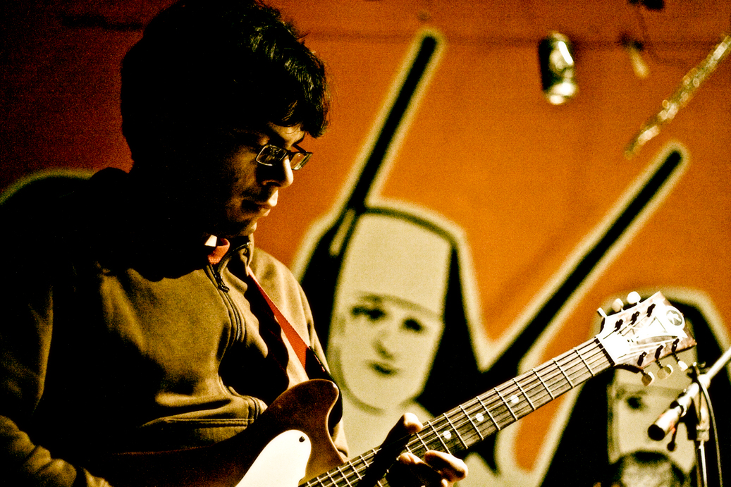 a man holding a guitar on a stage