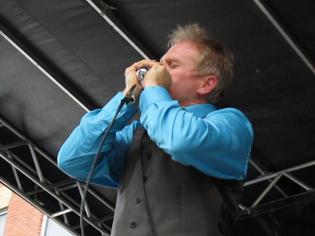 a man holding up a microphone to his face