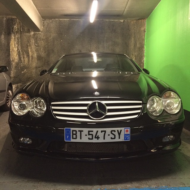 a black car parked in the garage of a building