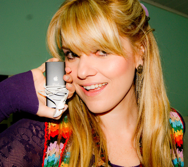 blond girl smiling and putting her hand in her mouth