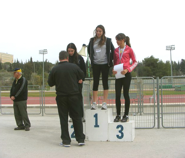 a group of s standing on the top of a small podium