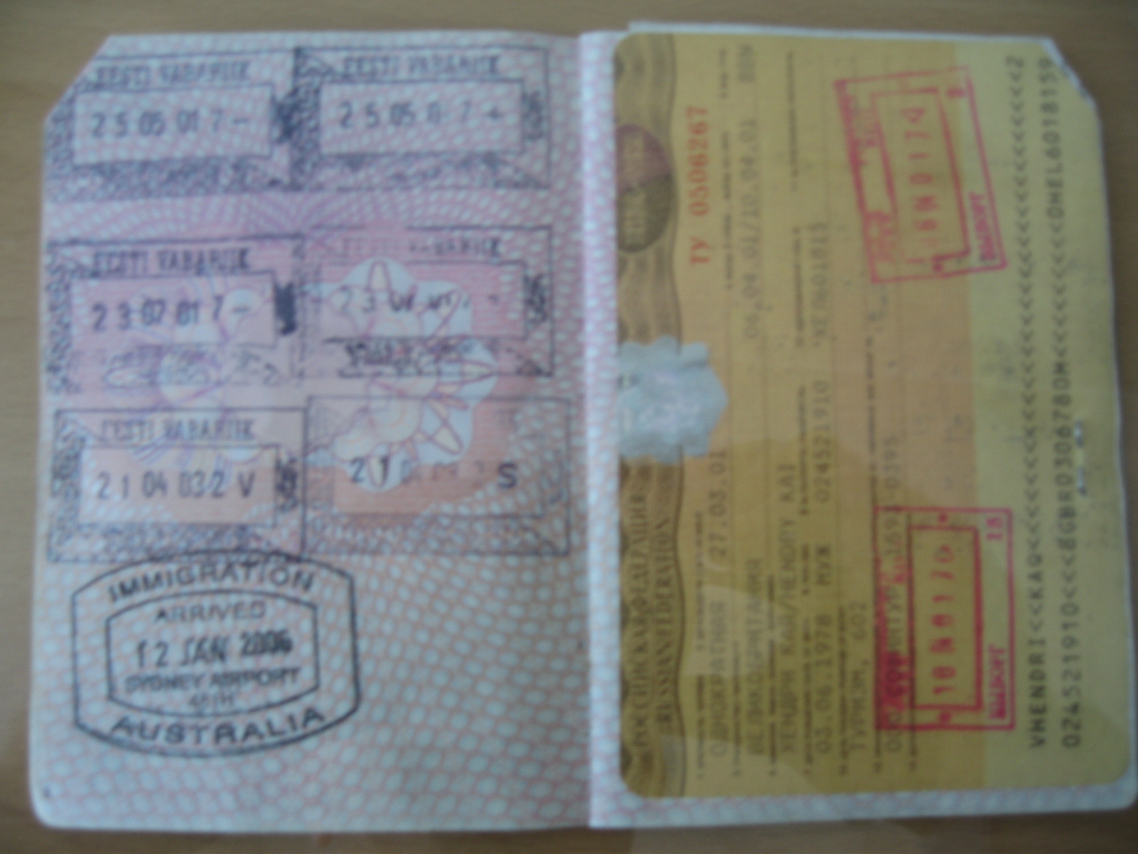 there are three passport id holders that have stamps on them