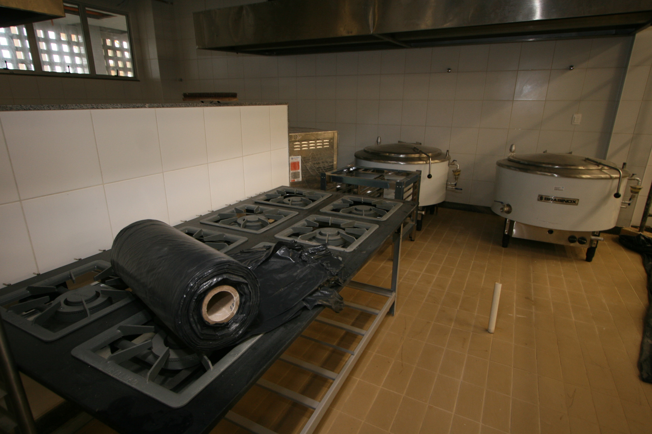 a kitchen with a stove, a microwave and some equipment