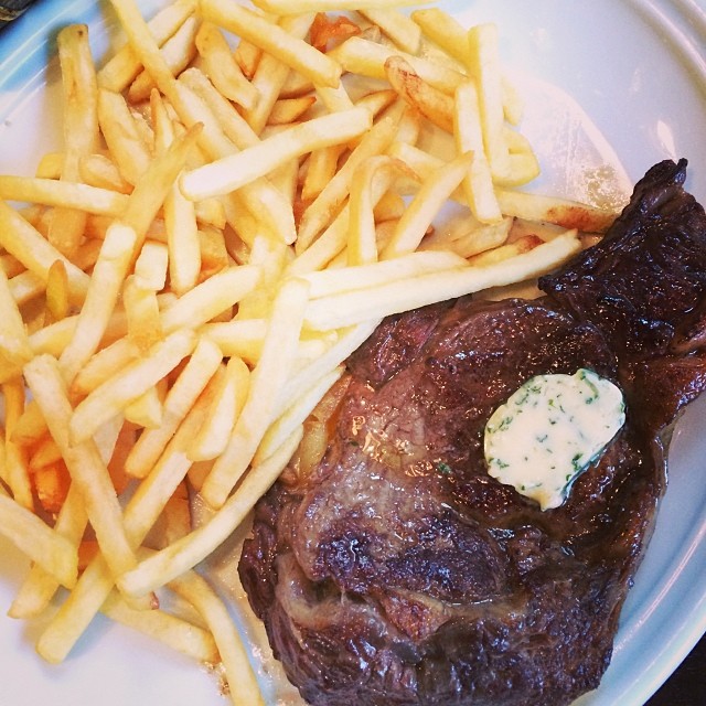 food on a plate of steak, french fries and blue cheese