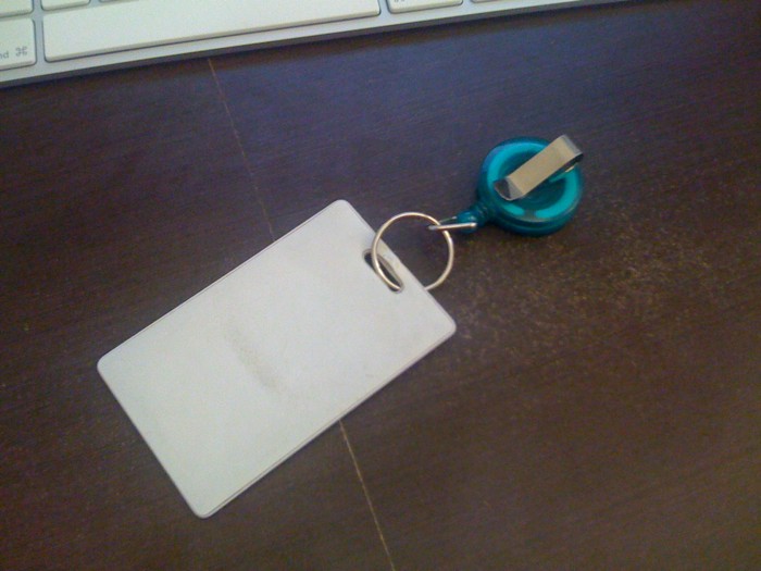 a keyring sitting on a piece of white paper next to a keyboard