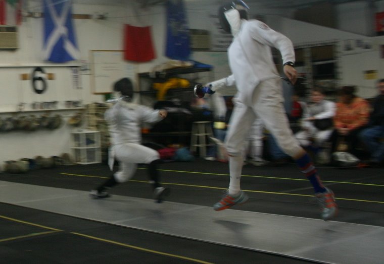 two men dancing on an indoor basketball court