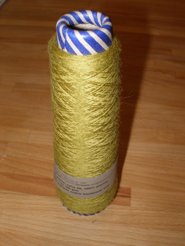 a spool of yellow twine sits on the floor