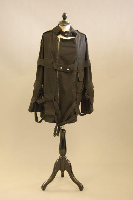 an old fashion jacket is displayed on a stand