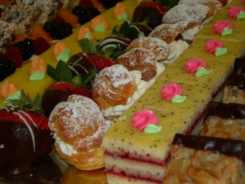a close up of a very long display of desserts
