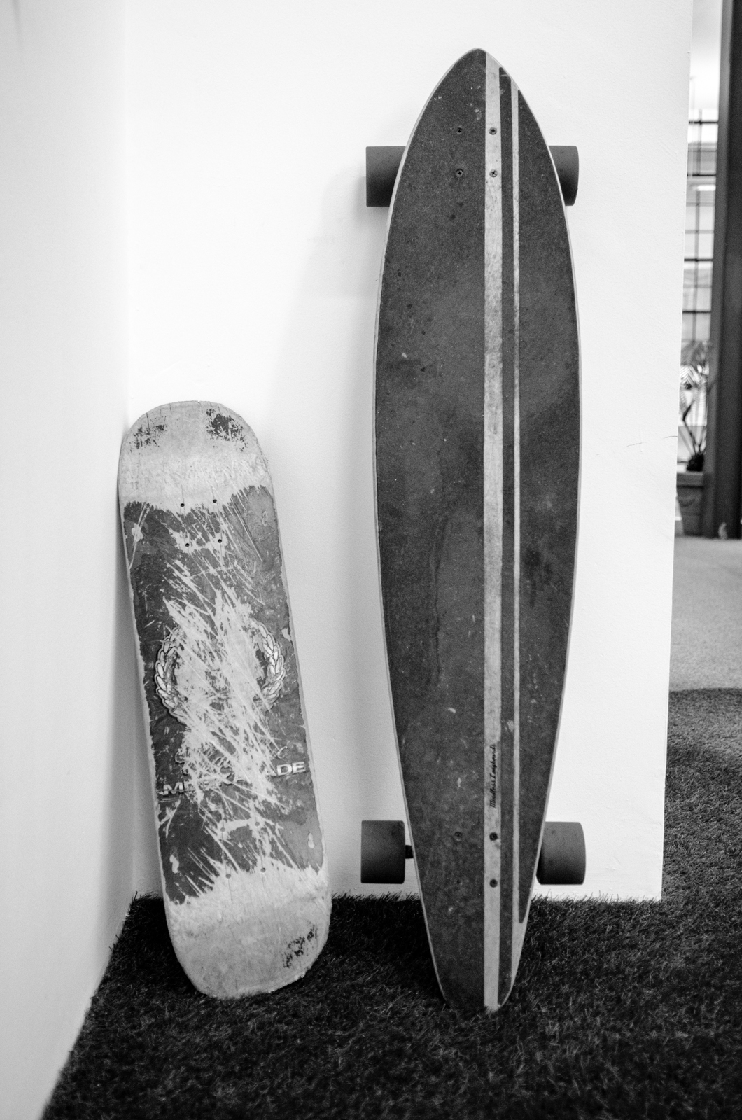 a skateboard sits next to a large skateboard