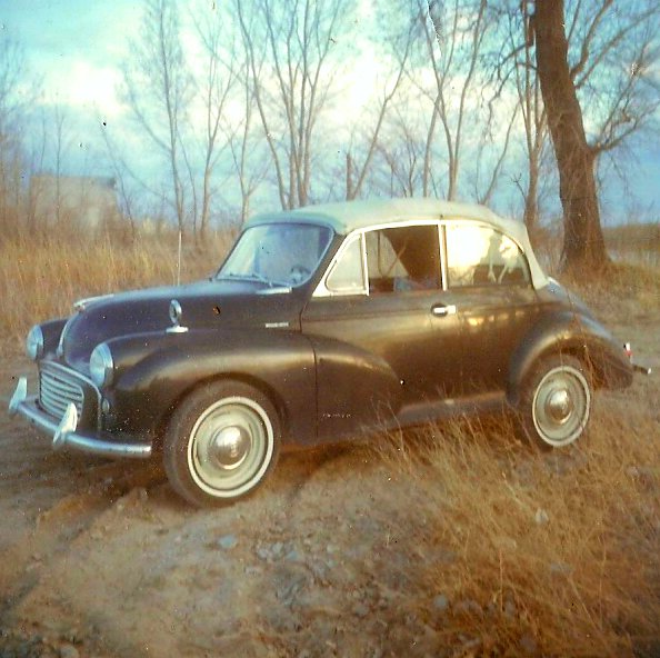 an old car that is sitting in the grass
