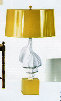 a white table and lamp sitting on top of a table