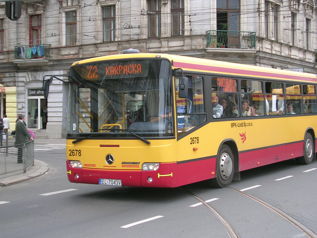 a yellow and red bus driving down a street