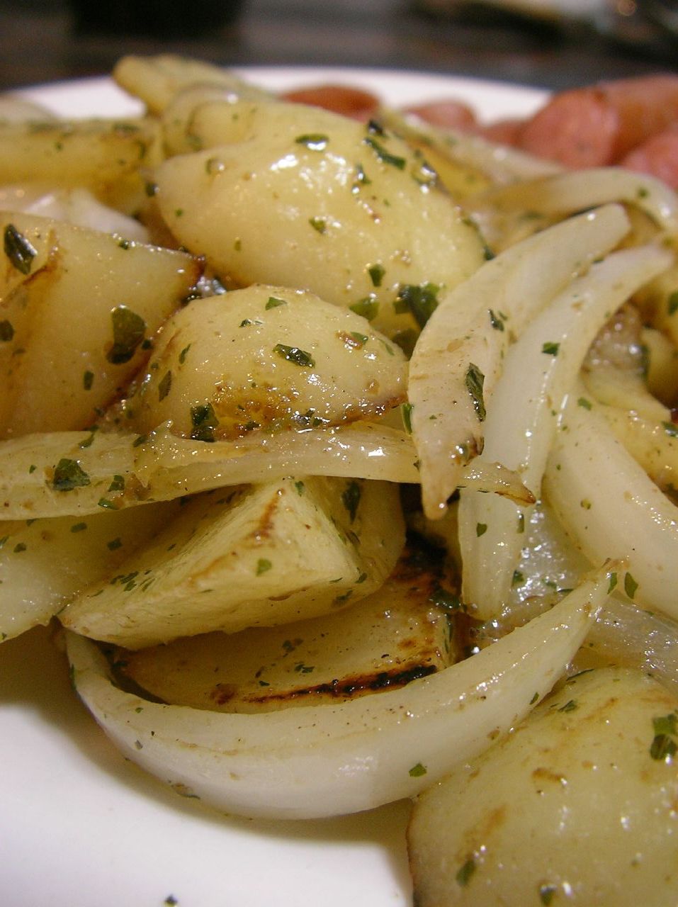 plate with onions and herbs on it and meat