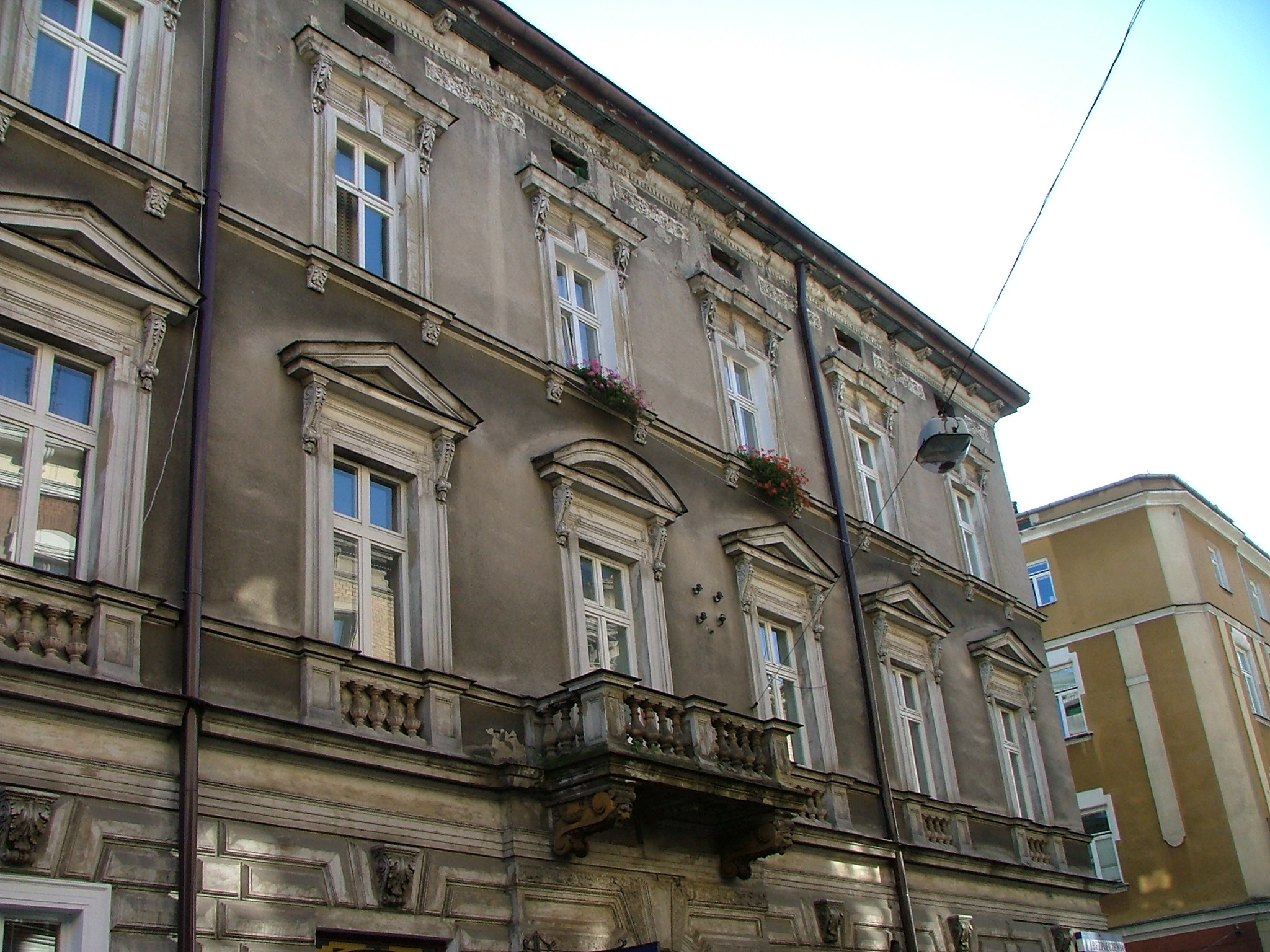 a building with some windows and balcony in front