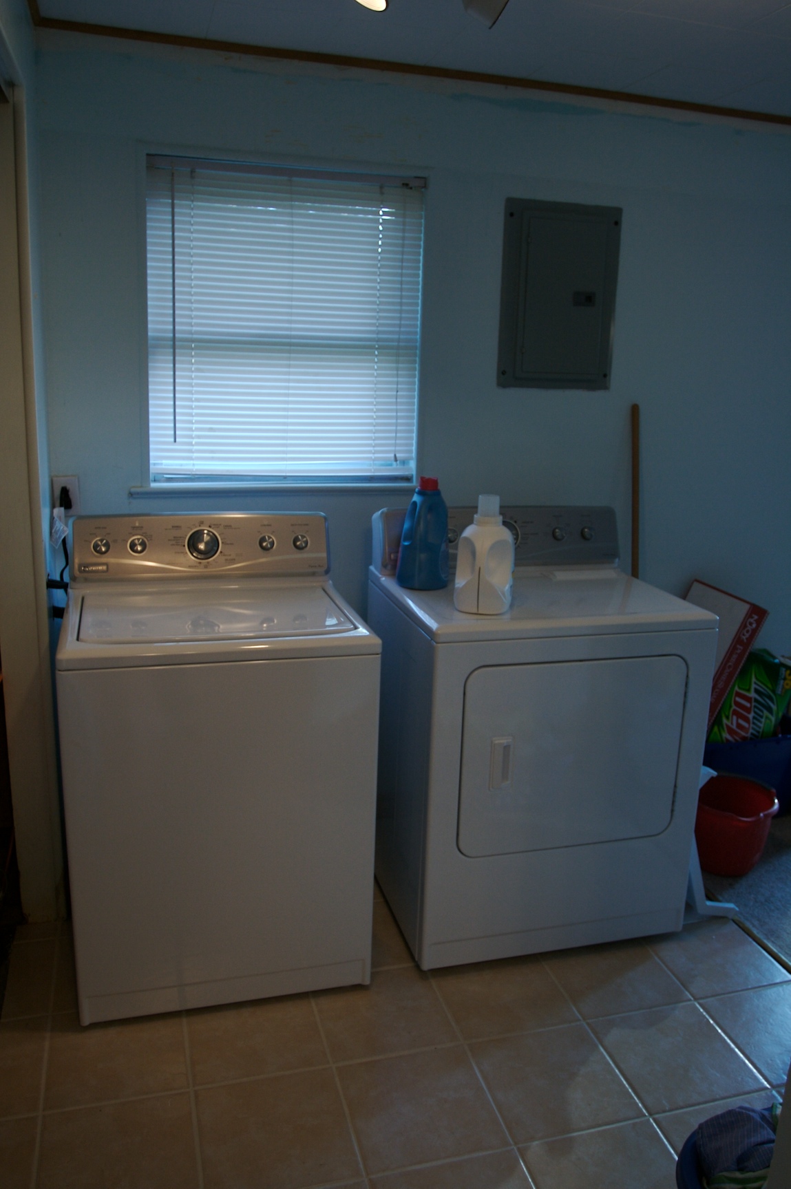 a small laundry room with two washers and a dryer