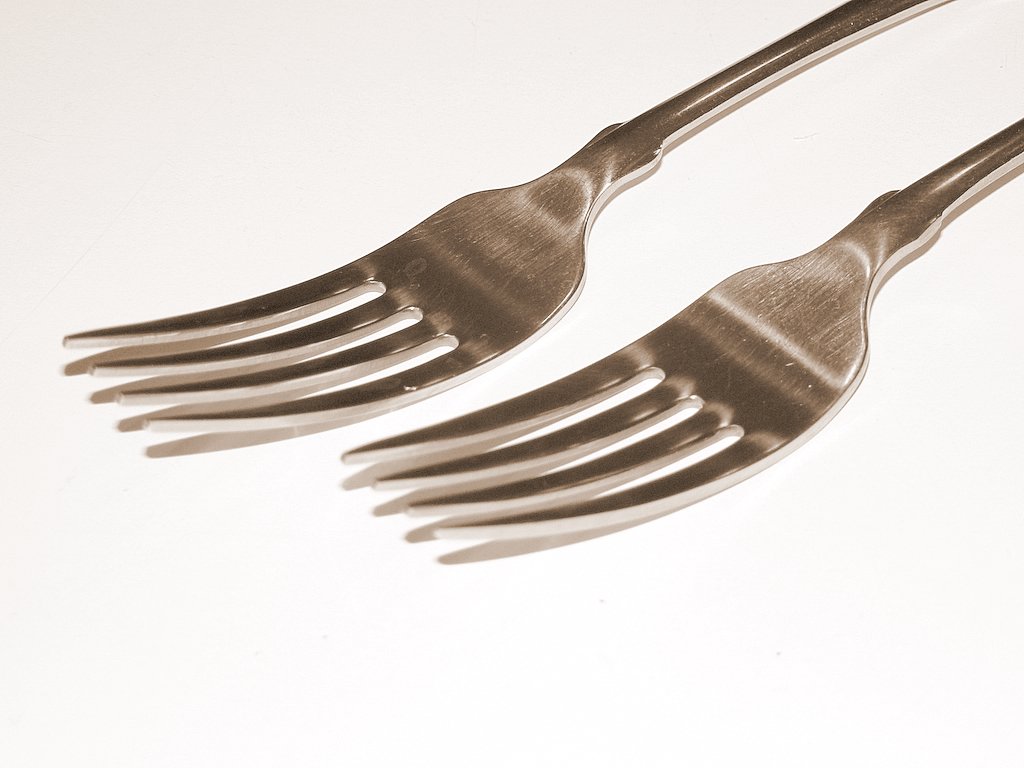 two silverware forks next to each other