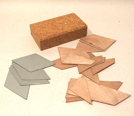 a block of wood and several pieces of rubber laying beside it