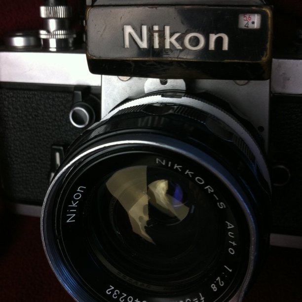 an old black and white camera with a nikon logo