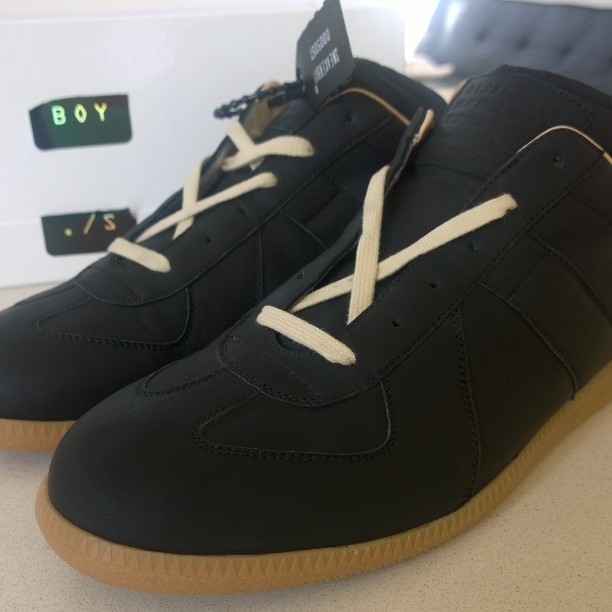 black shoes with white laces on a counter