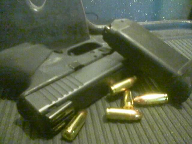 a gun and several bullet shells are shown from inside a car