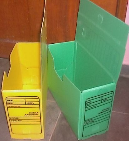 two cardboard storage boxes one green and one yellow