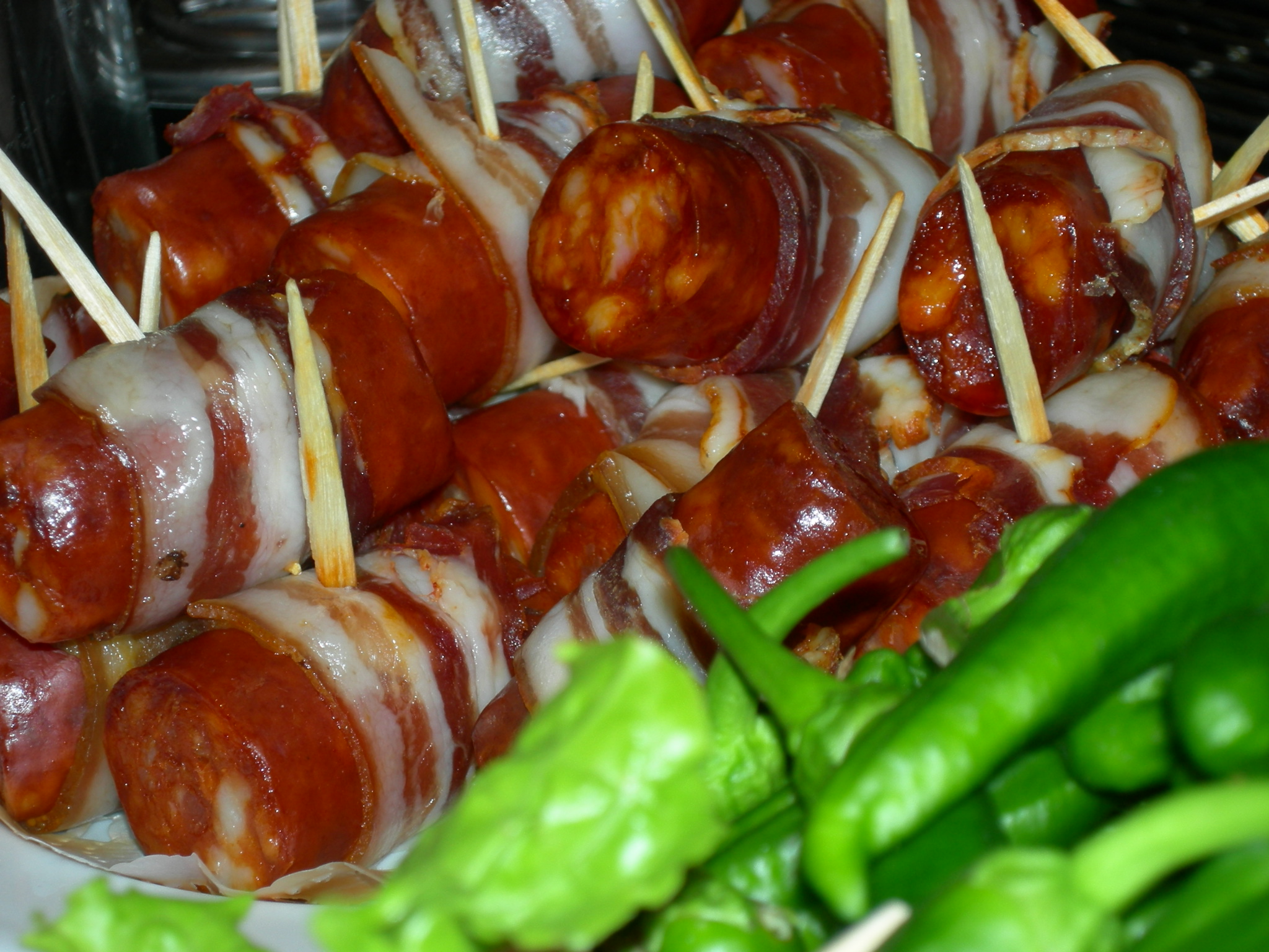 a plate full of cooked meats and green beans