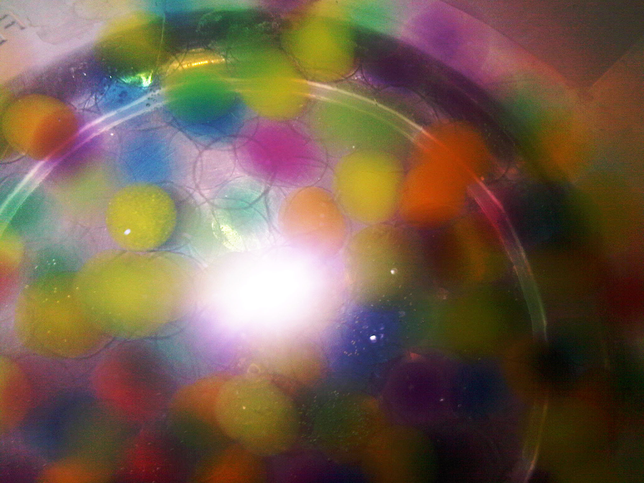 a multi - colored ball that has been placed in a bowl