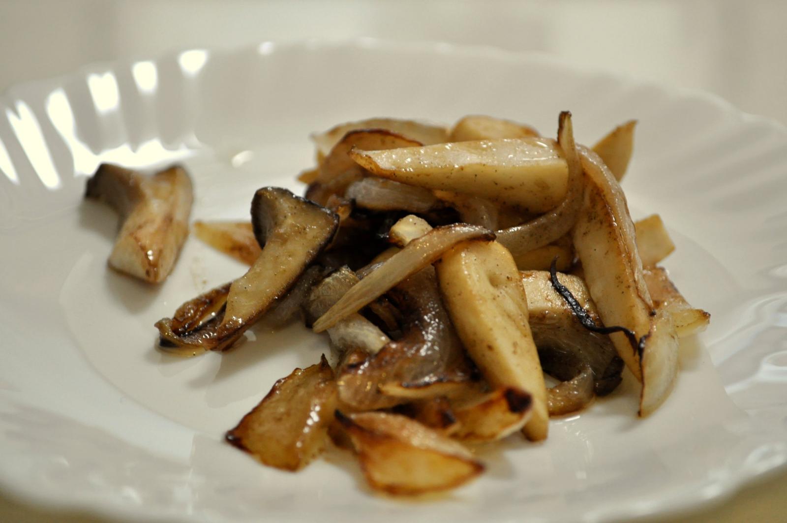 a plate has mushrooms on it with brown sauce