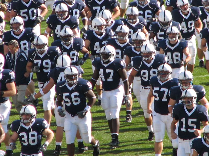 football team running onto the field after a game