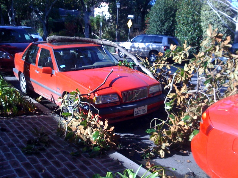 a car parked in the side of the street that has fallen over